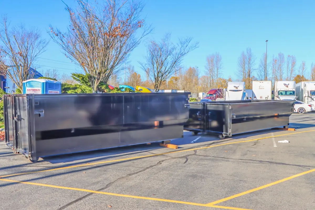 Professional dumpster rental service with roll-off container on residential driveway in Alamosa